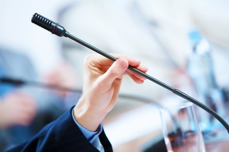 before a conference, the microphones in front of empty chairs..jpeg